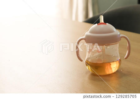 Barley tea in a baby's straw mug Barley tea in a baby's straw mug 129285705