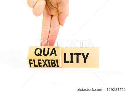 Quality or flexibility symbol. Concept words Quality Flexibility on wooden cubes. Beautiful white table white background. Businessman hand. Business and quality or flexibility concept. Copy space. Quality or flexibility symbol. Concept words Quality Flexibility on wooden cubes. Beautiful white table white background. Businessman hand. Business and quality or flexibility concept. Copy space. 129285721