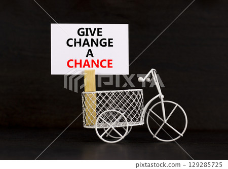 Give change a chance symbol. Concept words phrase Give change a chance on beautiful white paper on clothespin. Beautiful black paper background. Business Give change a chance concept. Copy space. 129285725