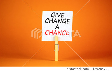 Give change a chance symbol. Concept words phrase Give change a chance on beautiful white paper on clothespin. Beautiful orange paper background. Business Give change a chance concept. Copy space. 129285729