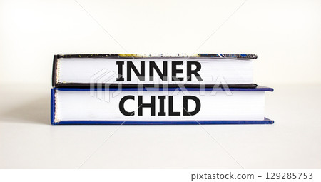 Inner child symbol. Concept words Inner child on beautiful books. Beautiful white table white background. Psychological, motivational inner child concept. Copy space. Inner child symbol. Concept words Inner child on beautiful books. Beautiful white table white background. Psychological, motivational inner child concept. Copy space. 129285753
