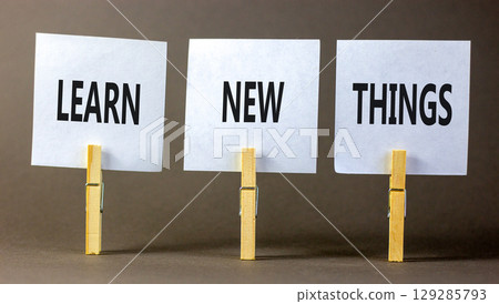 Learn new things symbol. Concept words Learn new things on beautiful white paper on clothespin. Beautiful grey background. Business motivational learn new things concept. Copy space. Learn new things symbol. Concept words Learn new things on beautiful white paper on clothespin. Beautiful grey background. Business motivational learn new things concept. Copy space. 129285793