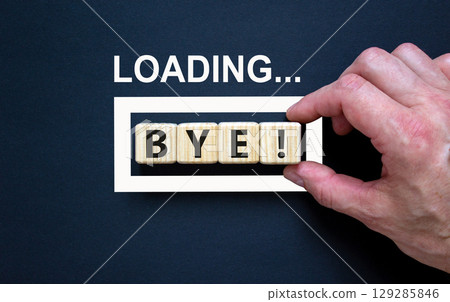 Bye symbol. Concept word Loading Bye on beautiful wooden blocks. Businessman hand. Beautiful black table black background. Business and bye concept. Copy space. Bye symbol. Concept word Loading Bye on beautiful wooden blocks. Businessman hand. Beautiful black table black background. Business and bye concept. Copy space. 129285846