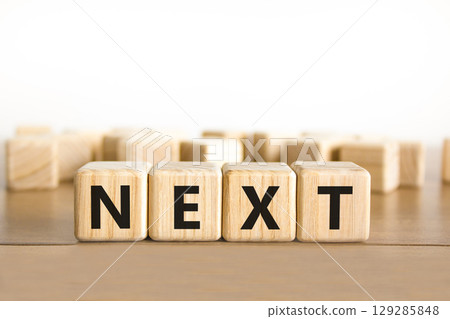 Next symbol. Concept word Next on beautiful wooden blocks. Beautiful wooden table white background. Business, lifestyle, support and next concept. Copy space. Next symbol. Concept word Next on beautiful wooden blocks. Beautiful wooden table white background. Business, lifestyle, support and next concept. Copy space. 129285848