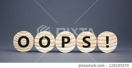 Oops symbol. Concept word Oops on beautiful wooden circles. Beautiful grey table grey background. Business lifestyle oops concept. Copy space. Oops symbol. Concept word Oops on beautiful wooden circles. Beautiful grey table grey background. Business lifestyle oops concept. Copy space. 129285870
