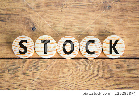 Stock symbol. Concept word Stock on beautiful wooden circles. Beautiful wooden table wooden background. Business lifestyle stock concept. Copy space. Stock symbol. Concept word Stock on beautiful wooden circles. Beautiful wooden table wooden background. Business lifestyle stock concept. Copy space. 129285874