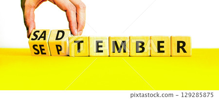 September is Sadtember symbol. Concept words September is Sadtember on beautiful wooden blocks. Beautiful white background. Businessman hand. Business September is Sadtember concept. Copy space. 129285875
