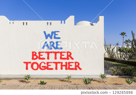 We are better together symbol. Concept words phrase We are better together on beautiful white wall. Beautiful white wall and blue sky background. Business We are better together concept. Copy space. We are better together symbol. Concept words phrase We are better together on beautiful white wall. Beautiful white wall and blue sky background. Business We are better together concept. Copy space. 129285898