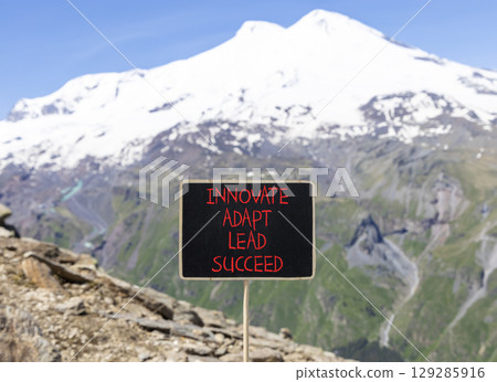 Innovate adapt lead succeed symbol. Concept words Innovate Adapt Lead Succeed on beautiful black blackboard. Beautiful mountain background. Business innovate adapt lead succeed concept Copy space 129285916