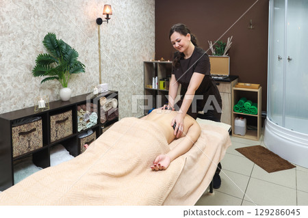 Relaxing Hot Stone Massage Therapy for Back and Neck Wellness, Promoting Relaxation and Healing 129286045