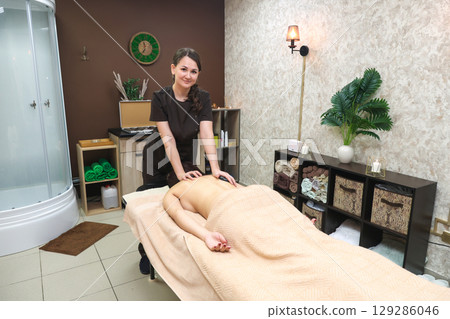 Relaxing Hot Stone Massage Therapy for Back and Neck Wellness, Promoting Relaxation and Healing 129286046