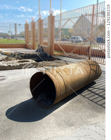 Repair of heating mains. Changing pipes in the city. Large metal pipe. Vertical Photo Repair of heating mains. Changing pipes in the city. Large metal pipe. Vertical Photo 129286219