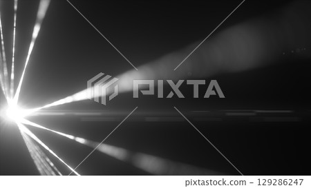 Black-and-white laser beams radiating from a blinding light source in the dark Black-and-white laser beams radiating from a blinding light source in the dark 129286247