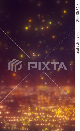 Glowing particles and lights in warm yellow-orange tones creating a dreamy starfield over a digital terrain 129286249