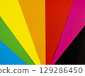 Brightly coloured sheets of paper arranged in a fan shape. A fan made of coloured paper. 129286450