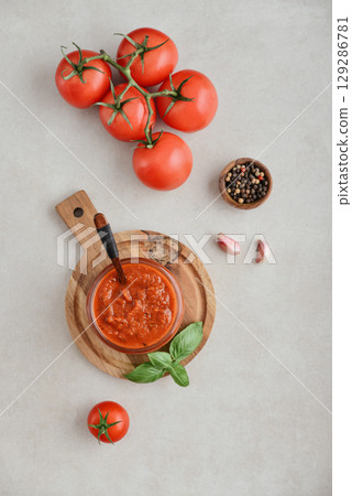 Traditional tomato sauce in a glass jar top view Traditional tomato sauce in a glass jar top view 129286781