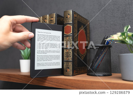 E-book reader device in home library 129286879