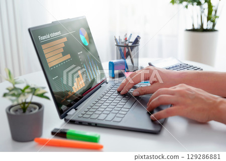 Man using 2 in 1 laptop to financial data analysis Man using 2 in 1 laptop to financial data analysis 129286881