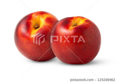 Two ripe organic nectarine peaches isolated. Juicy nectarine peach with clipping path. 129286962