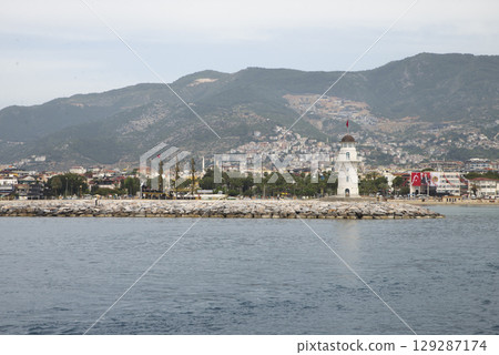 Panoramic view of old lighthouse in Alanya port. Landscape view of Mediterranean coast, Alanya, Turkey. High quality photo 129287174