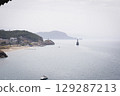 Stunning view of Calella de Palafrugell's pristine coastline featuring traditional whitewashed Mediterranean architecture, crystal-clear turquoise waters, and dramatic rocky outcrops along Costa Brava 129287213