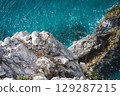 Stunning view of Calella de Palafrugell's pristine coastline featuring traditional whitewashed Mediterranean architecture, crystal-clear turquoise waters, and dramatic rocky outcrops along Costa Brava 129287215