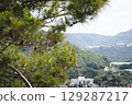 Stunning view of Calella de Palafrugell's pristine coastline featuring traditional whitewashed Mediterranean architecture, crystal-clear turquoise waters, and dramatic rocky outcrops along Costa Brava 129287217