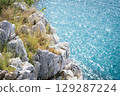 Stunning view of Calella de Palafrugell's pristine coastline featuring traditional whitewashed Mediterranean architecture, crystal-clear turquoise waters, and dramatic rocky outcrops along Costa Brava 129287224