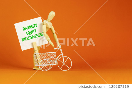 DEI diversity equity inclusiveness symbol. Concept words Diversity Equity Inclusiveness on white card. Beautiful orange background. Business DEI diversity equity inclusiveness concept. Copy space. 129287319