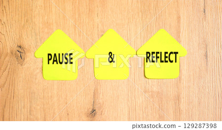 Pause and reflect symbol. Concept words Pause and reflect on beautiful yellow paper houses. Beautiful wooden background. Business motivational lifestyle pause and reflect concept. Copy space. 129287398