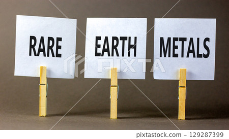 Rare earth metals symbol. Concept words Rare earth metals on beautiful white paper on wooden clothespin. Beautiful grey background. Business and rare earth metals concept. Copy space. Rare earth metals symbol. Concept words Rare earth metals on beautiful white paper on wooden clothespin. Beautiful grey background. Business and rare earth metals concept. Copy space. 129287399