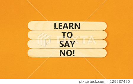 Learn to say no symbol. Concept words phrase Learn to say no on beautiful wooden stick. Beautiful orange paper background. Business psychological Learn to say no concept. Copy space. 129287450