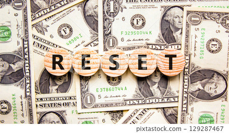 Reset symbol. Concept word Reset on beautiful wooden circles. Beautiful dollar bills. Beautiful background from dollar bills. Business lifestyle reset concept. Copy space. 129287467