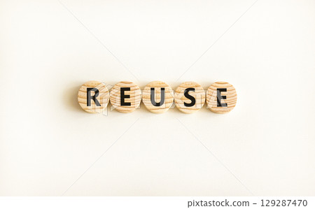 Reuse symbol. Concept word Reuse on beautiful wooden circles. Beautiful white table white background. Business lifestyle ecological reuse concept. Copy space. Reuse symbol. Concept word Reuse on beautiful wooden circles. Beautiful white table white background. Business lifestyle ecological reuse concept. Copy space. 129287470