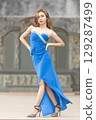 Elegant Woman in Blue Strapless Gown Posing 129287499