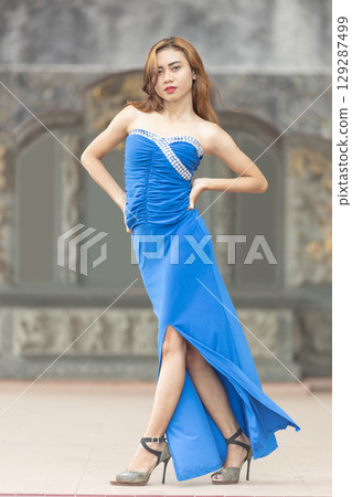 Elegant Woman in Blue Strapless Gown Posing Elegant Woman in Blue Strapless Gown Posing 129287499
