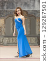 Elegant Woman in Blue Strapless Gown Posing 129287501