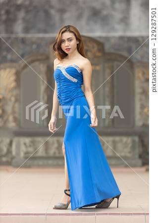 Elegant Woman in Blue Strapless Gown Posing Elegant Woman in Blue Strapless Gown Posing 129287501