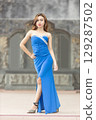 Elegant Woman in Blue Strapless Gown Posing 129287502