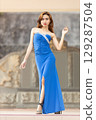 Elegant Woman in Blue Strapless Gown Posing 129287504
