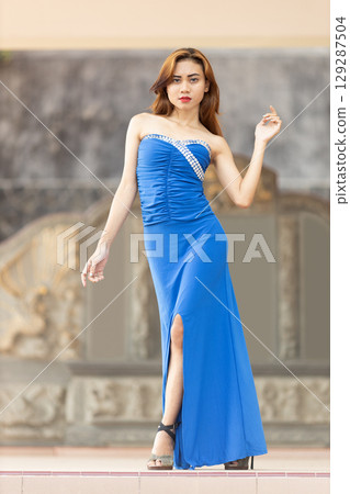 Elegant Woman in Blue Strapless Gown Posing 129287504