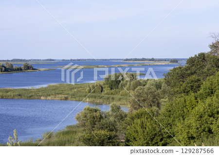 Russian landscape with Volga river on a sunny day. Bolgar, Tatarstan, Russia. View on the valley of Volga river from the hill. Peaceful nature. Beautiful background. Russian landscape with Volga river on a sunny day. Bolgar, Tatarstan, Russia. View on the valley of Volga river from the hill. Peaceful nature. Beautiful background. 129287566