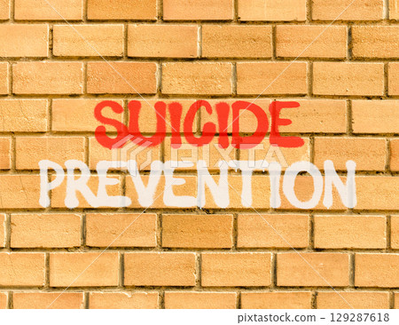 Suicide prevention symbol. Concept words Suicide prevention on beautiful brick wall. Beautiful brick wall background. Psychological and suicide prevention concept. Copy space. Suicide prevention symbol. Concept words Suicide prevention on beautiful brick wall. Beautiful brick wall background. Psychological and suicide prevention concept. Copy space. 129287618