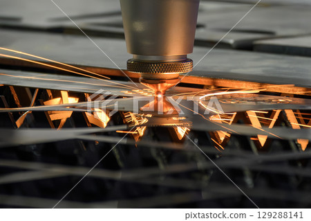 Close up scene the fiber laser cutting machine cut the metal plate control by CNC program. 129288141