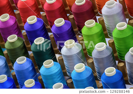 Close up the multi-color group of industry bobbin thread. Close up the multi-color group of industry bobbin thread. 129288146