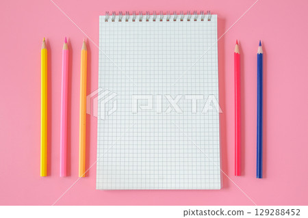 Top view of notebook and color pencil on background. 129288452