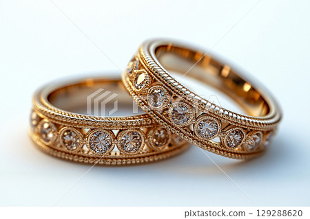 Luxury pair of Wedding Rings on a white background. Rococo Renaissance style. 129288620