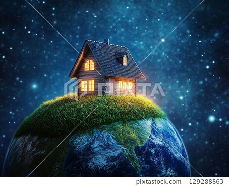 A tiny, cozy house with glowing windows sits atop a grassy hill on a small Earth, floating in a starry, celestial space. 129288863
