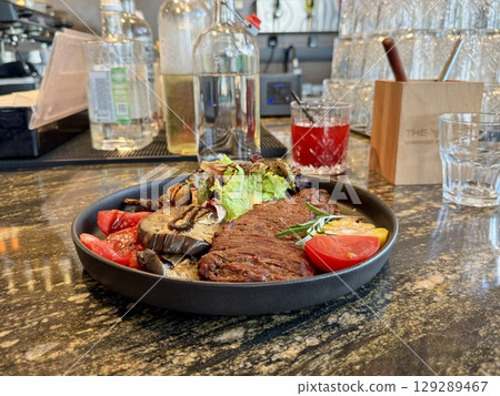 grilled beef steak with vegetables in a restaurant. High quality photo grilled beef steak with vegetables in a restaurant. High quality photo 129289467