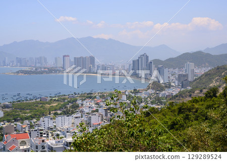 View from the mountain to the city with skyscrapers on the shore of the Gulf of the South China Sea 129289524